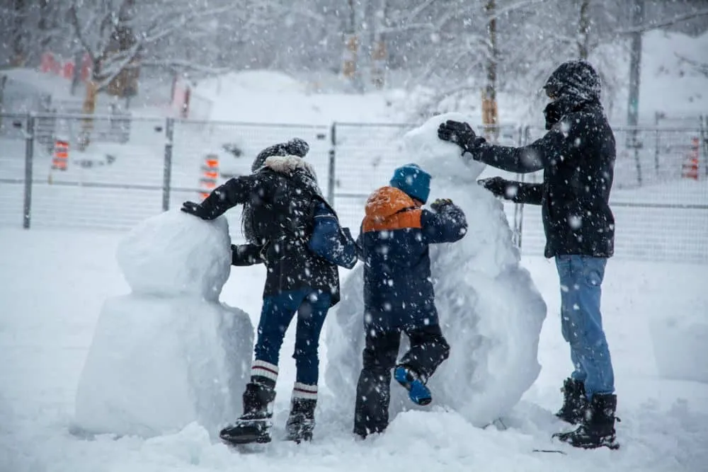 Building a snowman during Winter in Montreal